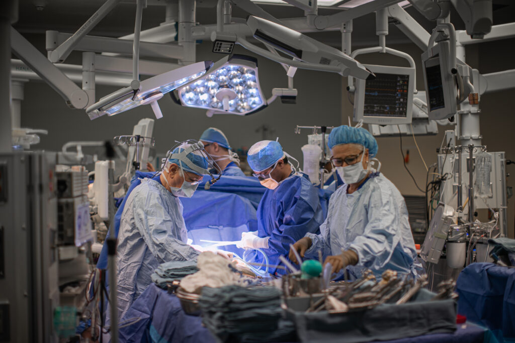 Dr. Tirone David collaborates with other team members in the operating room.